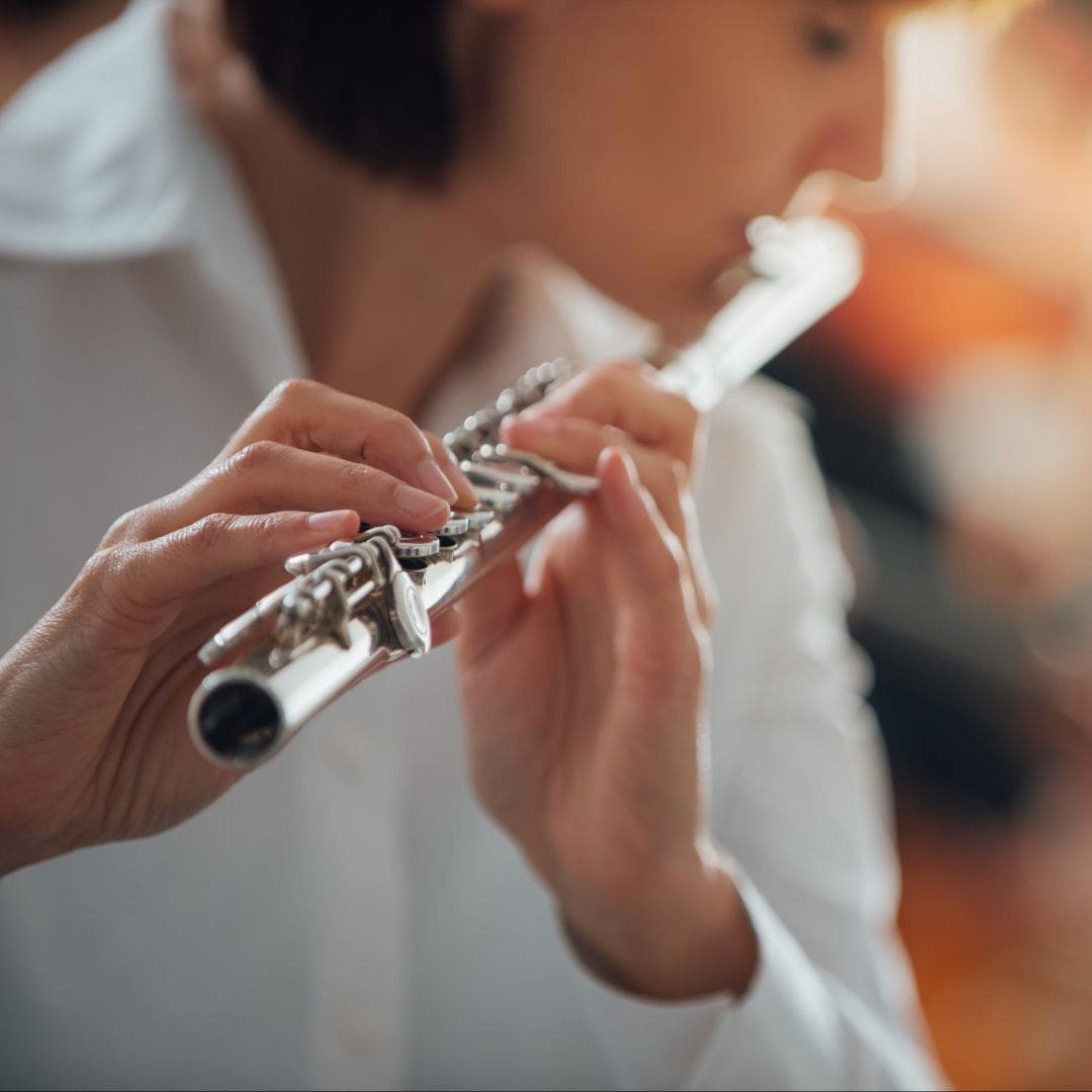 a picture of a woman playing a flute