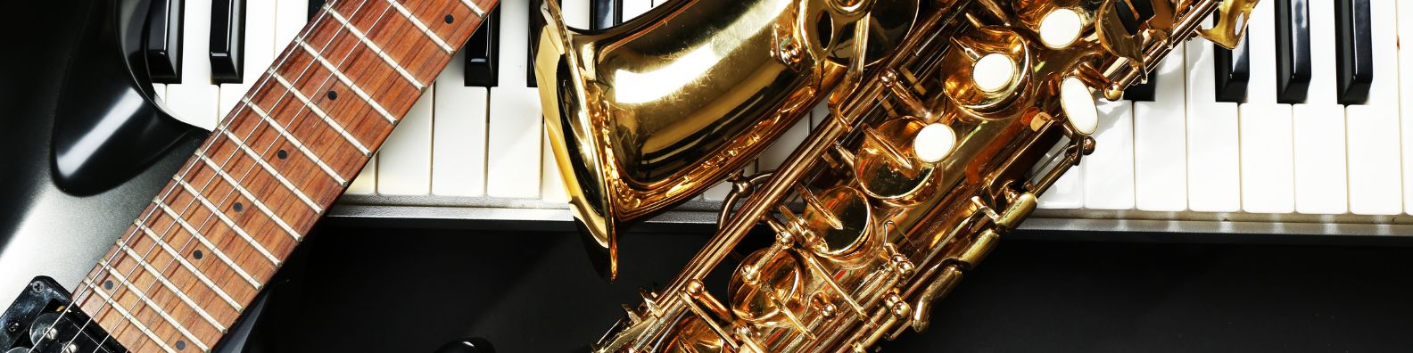 An image showing various instruments including a guitar, saxophone and keyboard